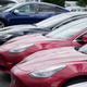 In this Sunday, June 27, 2021, photograph, a handful of unsold 2021 Model 3 sedans sits in a near-empty lot at a Tesla dealership in Littleton, Colo. The company faces a new lawsuit alleging mistreatment of a Black woman at one of its plants.